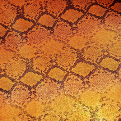 Close-up of a textured fabric with a geometric pattern in orange and brown tones.[designerspandexandmore.com]