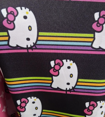 Hello Kitty fabric with rainbow stripes on a black background. [designerspandexandmore.com]